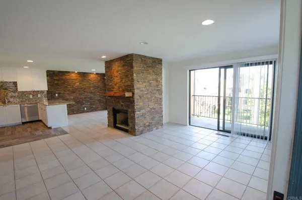 a view of a kitchen with furniture and an empty room