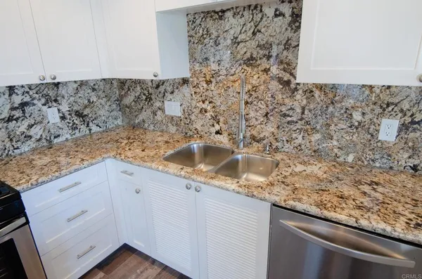 a view of a sink microwave and cabinets