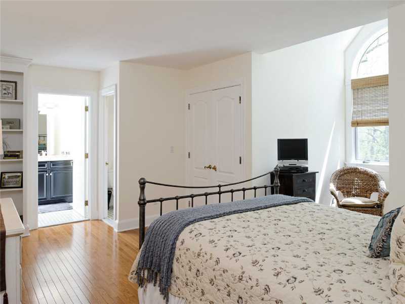102 Long Close Road Stamford, CT 06902 - Photo 13 of 25 a bedroom with a bed and wooden floor