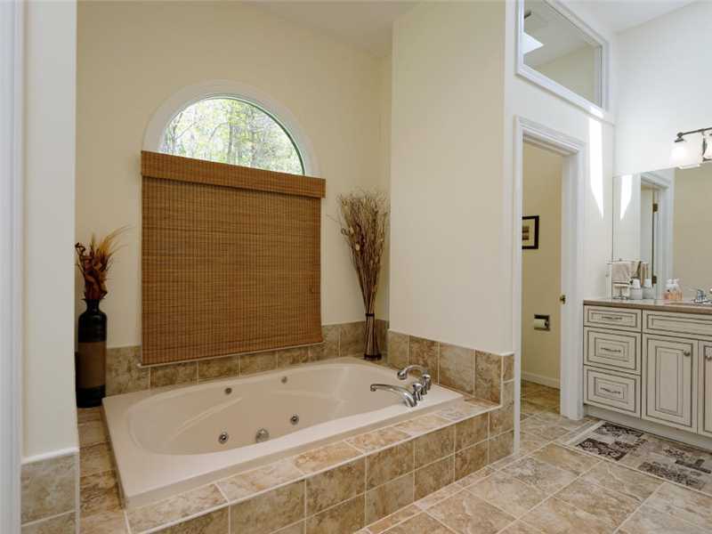 102 Long Close Road Stamford, CT 06902 - Photo 7 of 25 a bathroom with a tub sink and mirror