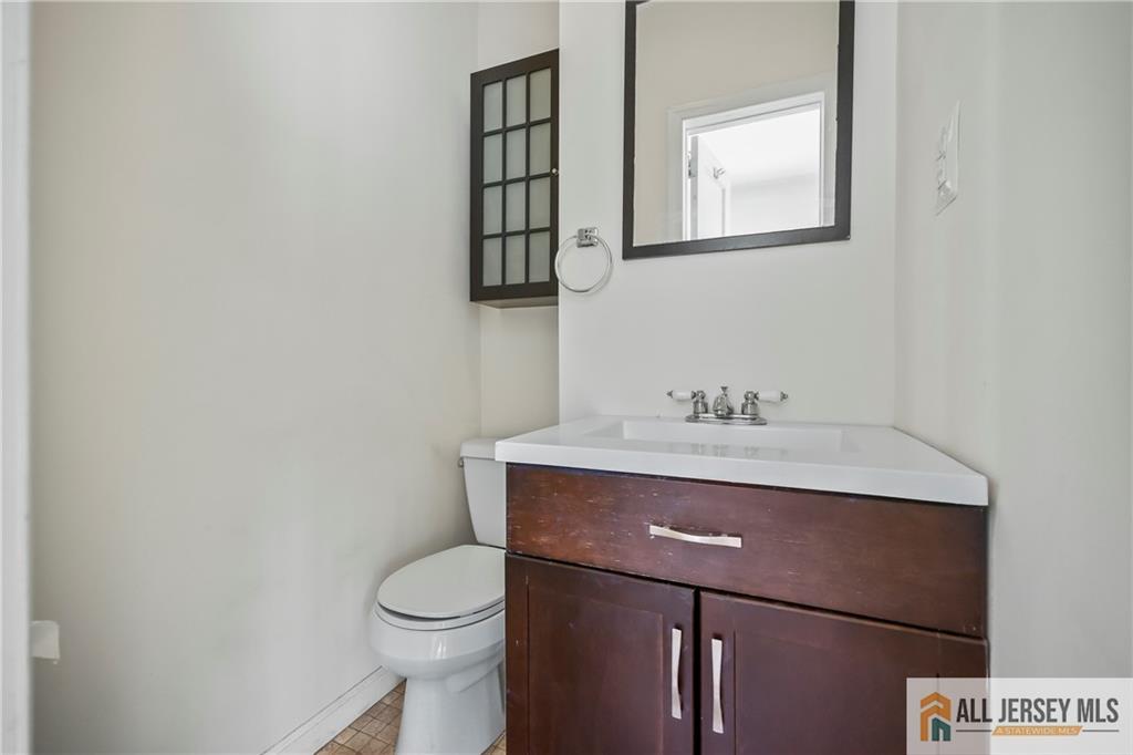 205 Ashland Road Middlesex, NJ 08846 - Photo 12 of 50 a bathroom with a sink a toilet and mirror