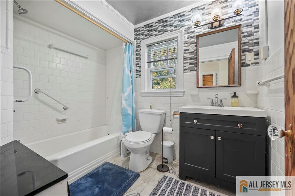 205 Ashland Road Middlesex, NJ 08846 - Photo 20 of 50 a bathroom with a sink toilet a mirror and shower