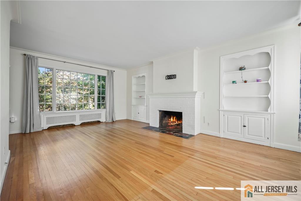 205 Ashland Road Middlesex, NJ 08846 - Photo 39 of 50 a view of empty room with wooden floor and fireplace