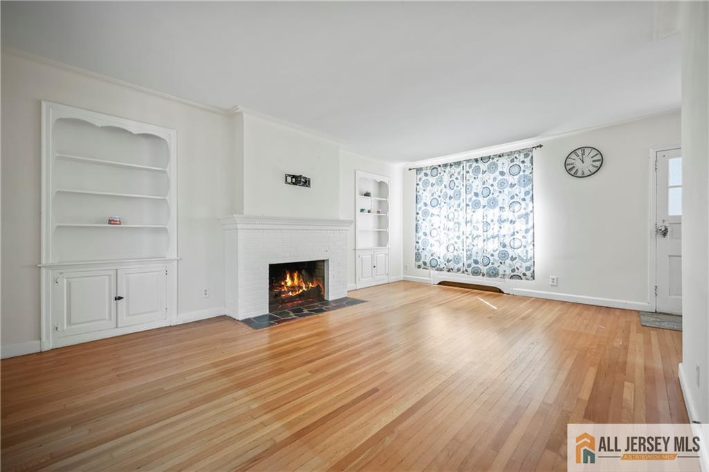 205 Ashland Road Middlesex, NJ 08846 - Photo 40 of 50 an empty room with wooden floor fireplace and windows