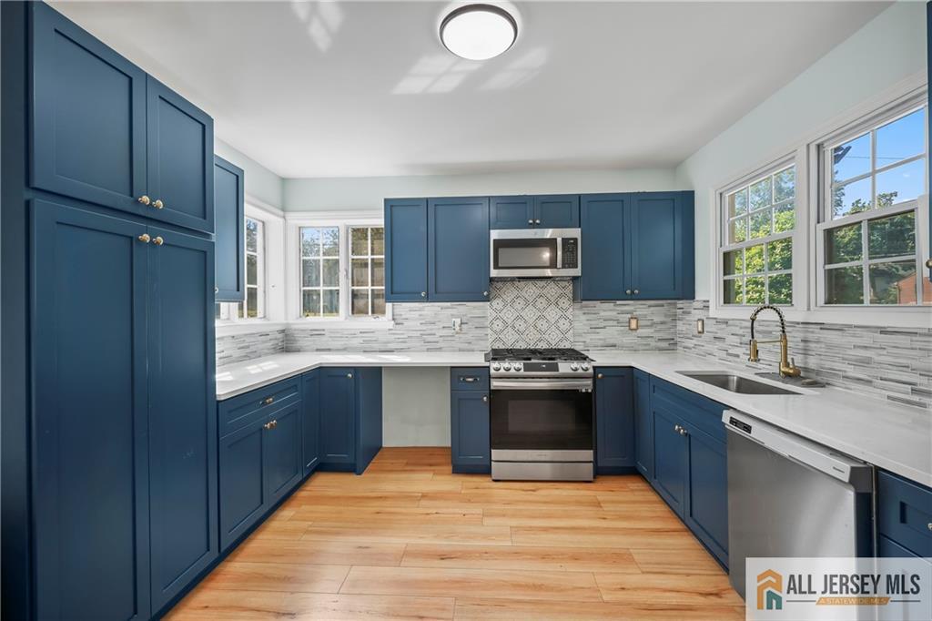 205 Ashland Road Middlesex, NJ 08846 - Photo 5 of 50 a kitchen with granite countertop a sink cabinets stainless steel appliances and a window