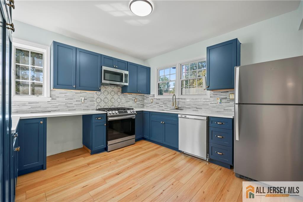 205 Ashland Road Middlesex, NJ 08846 - Photo 6 of 50 a kitchen with stainless steel appliances granite countertop a sink stove and refrigerator