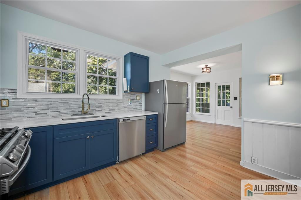 205 Ashland Road Middlesex, NJ 08846 - Photo 8 of 50 a kitchen with stainless steel appliances granite countertop a refrigerator a sink dishwasher and wooden cabinets with wooden floor