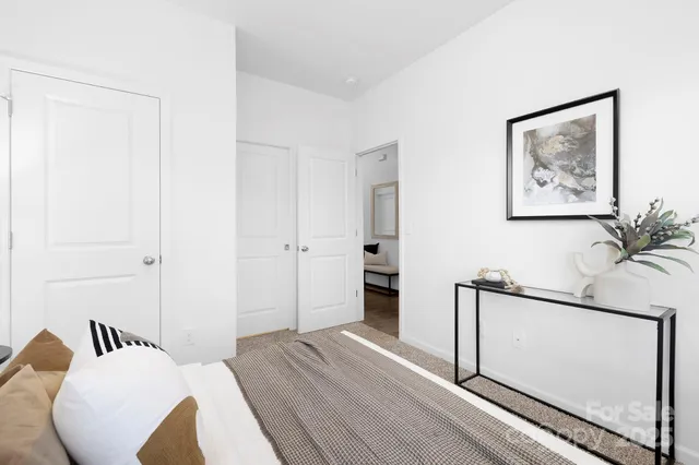 a bedroom with a bed and a painting on the wall