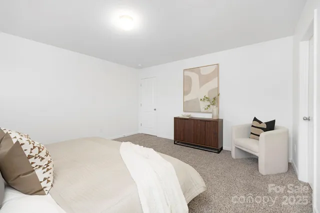 a bedroom with a bed and a couch