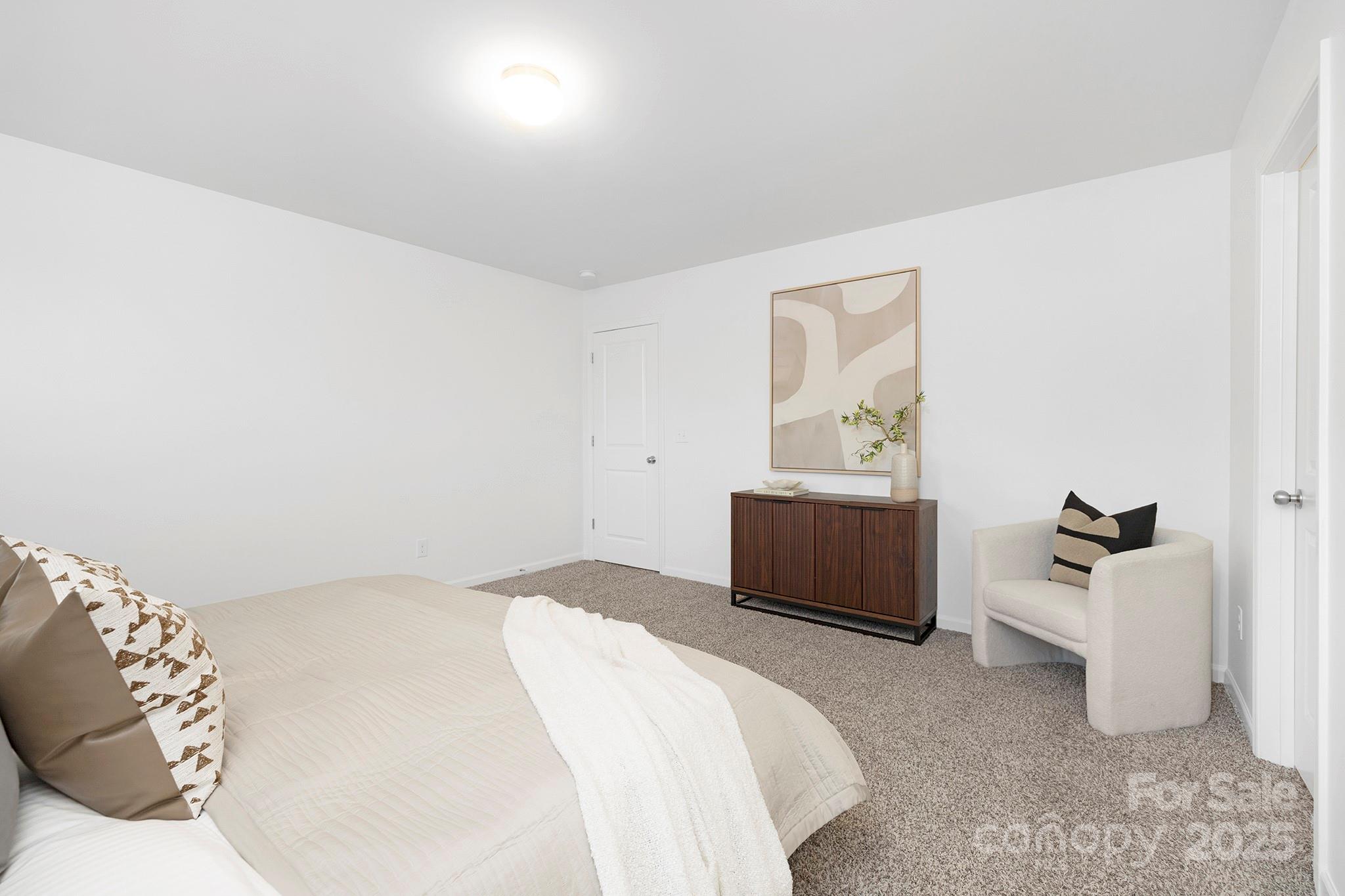 12970 Hill Pine Road, Unit 248 Midland, NC 28107 - Photo 15 of 30 a bedroom with a bed and a couch