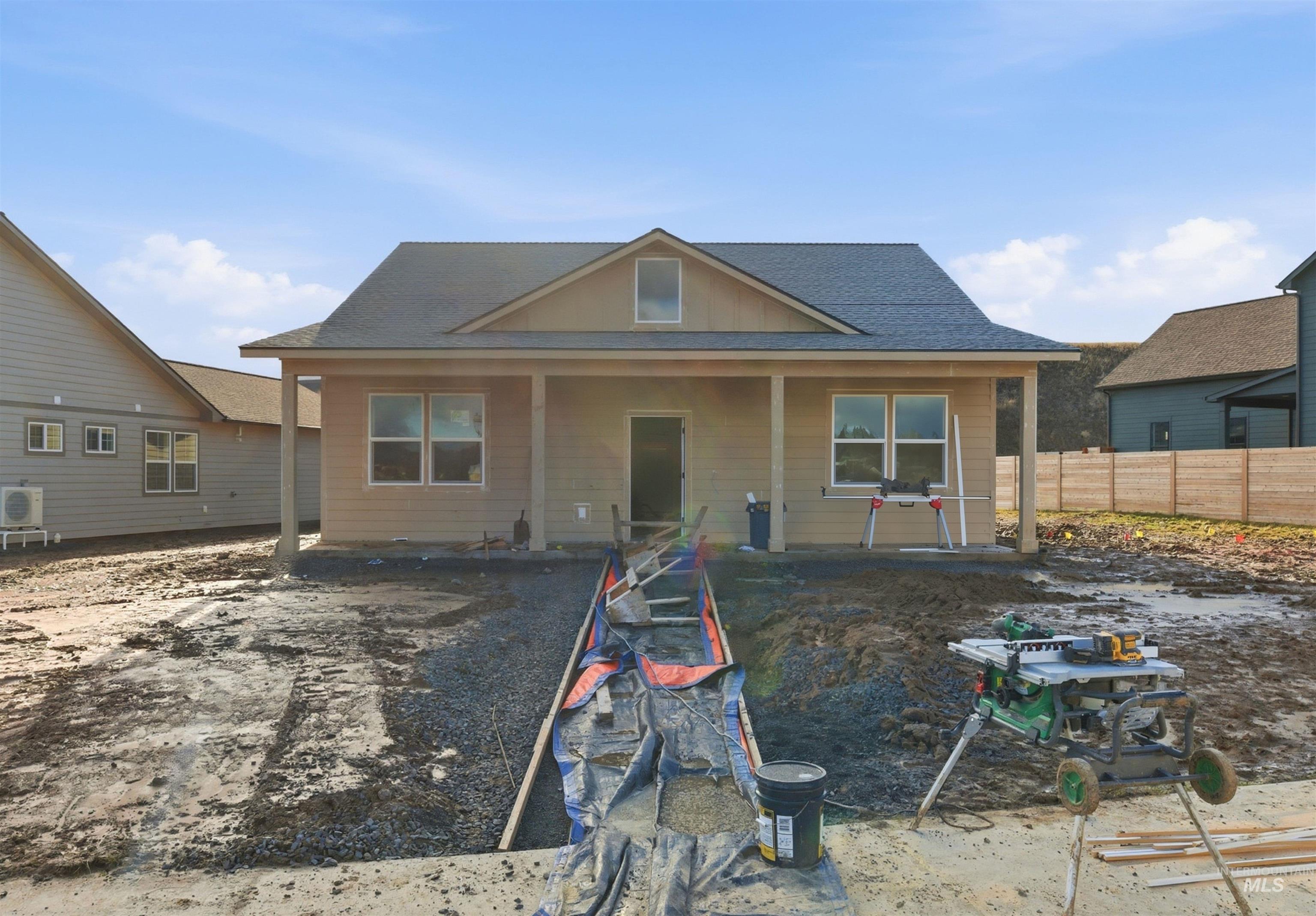 View of front facade featuring roof with shingles and covered porch