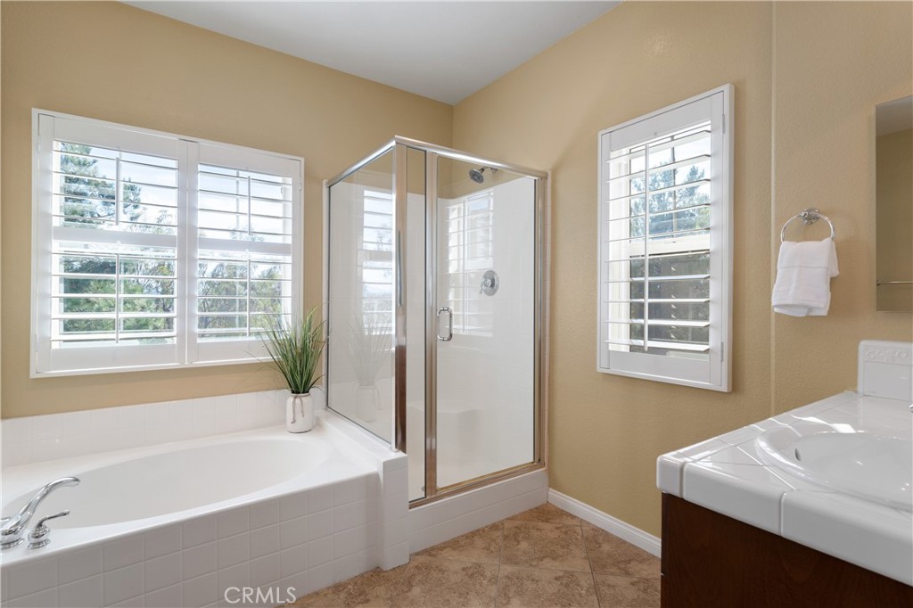 28817 Edenton Way Temecula, CA 92591 - Photo 32 of 56 a bathroom with a bathtub a sink and a shower