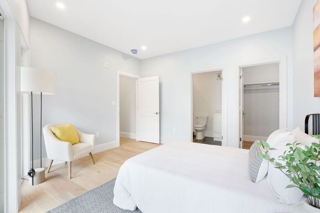 21 Glen Road, Unit 2 Boston, MA 02130 - Photo 7 of 13 a bedroom with a bed and a chair