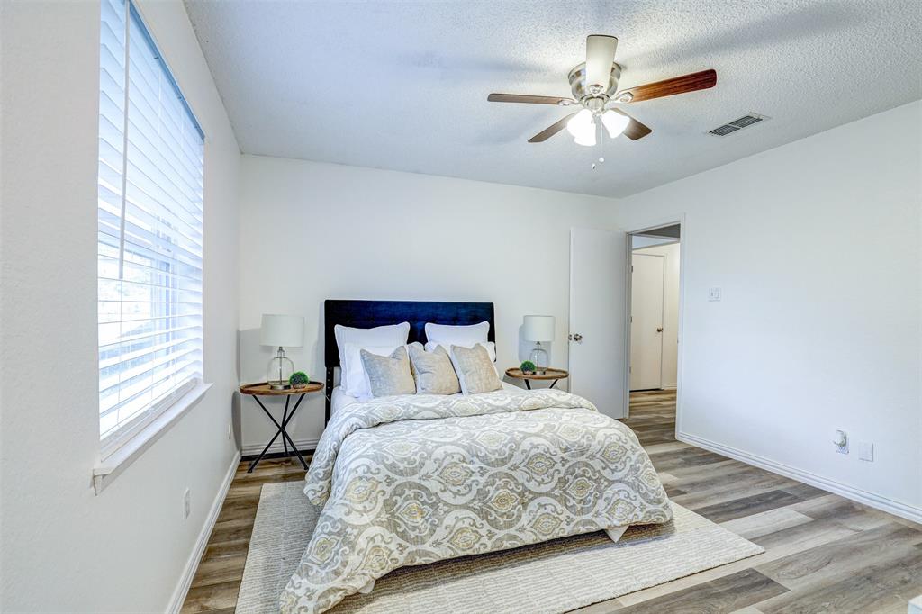 6005 Oak Hill Road Watauga, TX 76148 - Photo 14 of 22 a bedroom with a bed and a ceiling fan