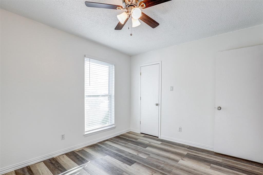 6005 Oak Hill Road Watauga, TX 76148 - Photo 17 of 22 a view of an empty room with window and a chandelier fan