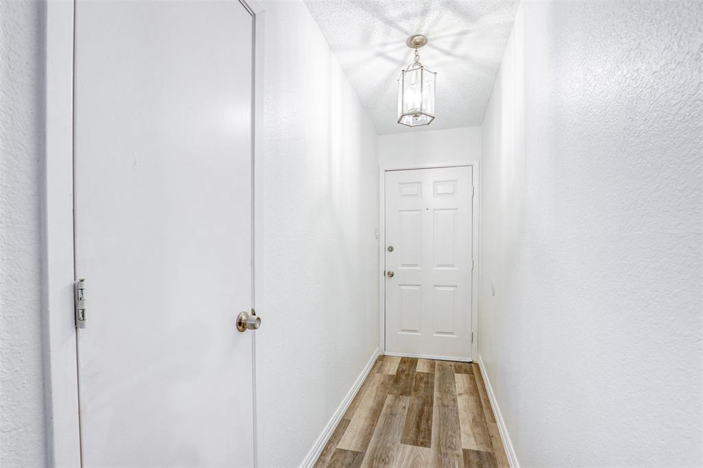 6005 Oak Hill Road Watauga, TX 76148 - Photo 20 of 22 a view of a hallway with wooden floor