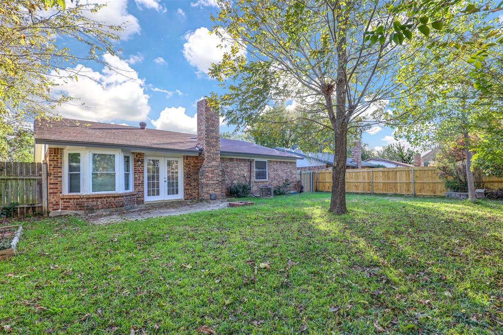 6005 Oak Hill Road Watauga, TX 76148 - Photo 22 of 22 a view of a yard in front of a house with large trees