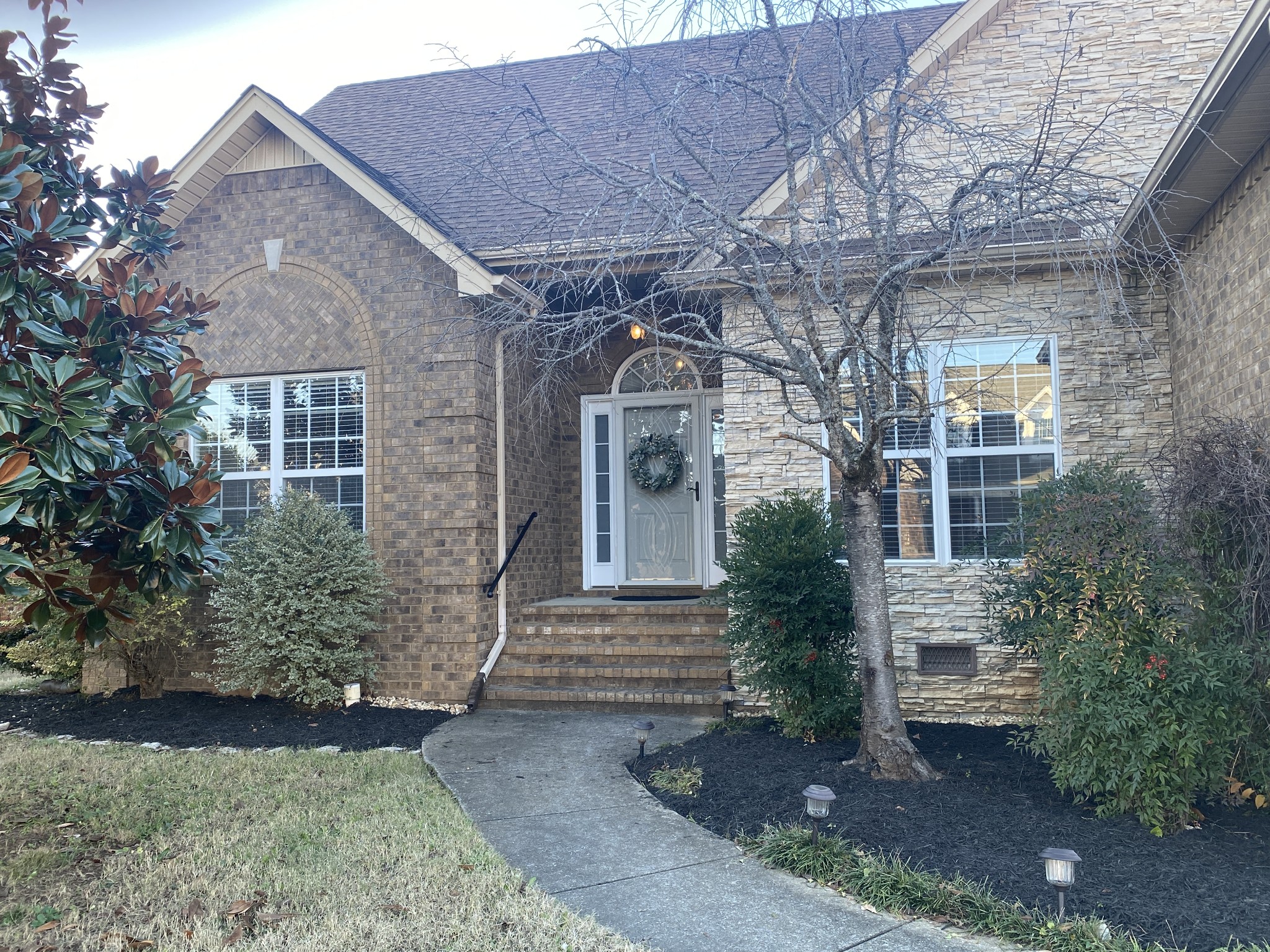 a front view of a house with garden