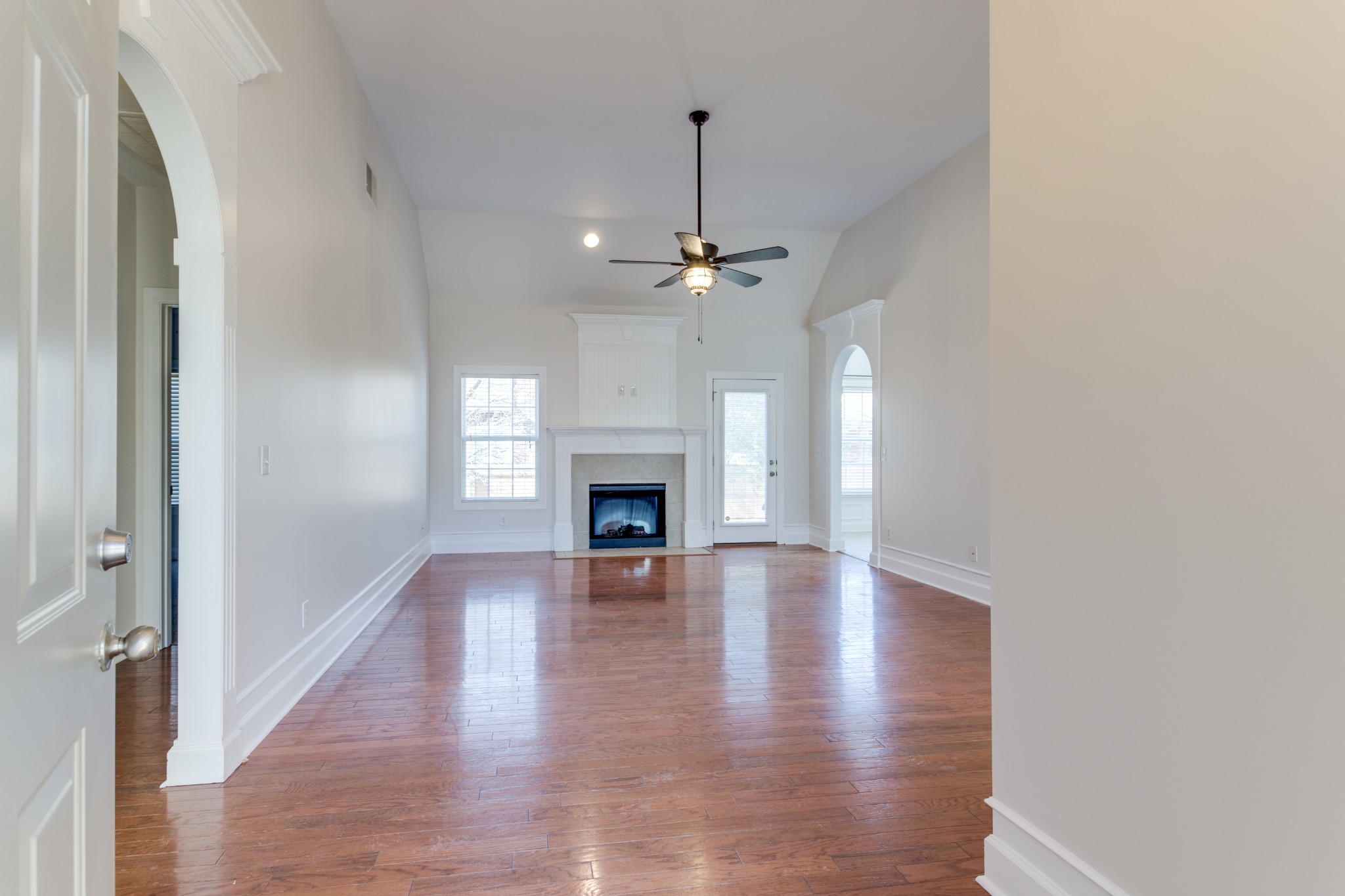 433 Bethany Circle Murfreesboro, TN 37128 - Photo 8 of 23 a view of an empty room with wooden floor fireplace and a window