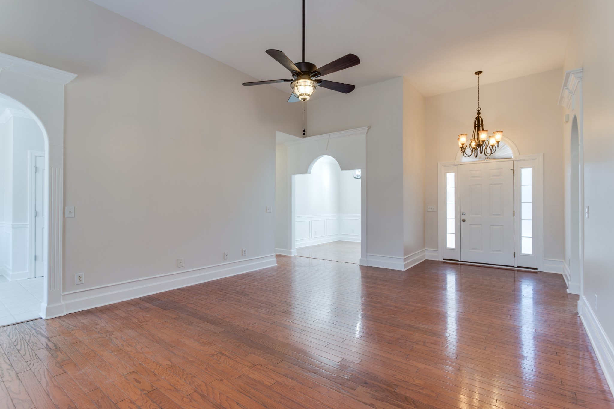 433 Bethany Circle Murfreesboro, TN 37128 - Photo 9 of 23 a view of an empty room with wooden floor and a ceiling fan