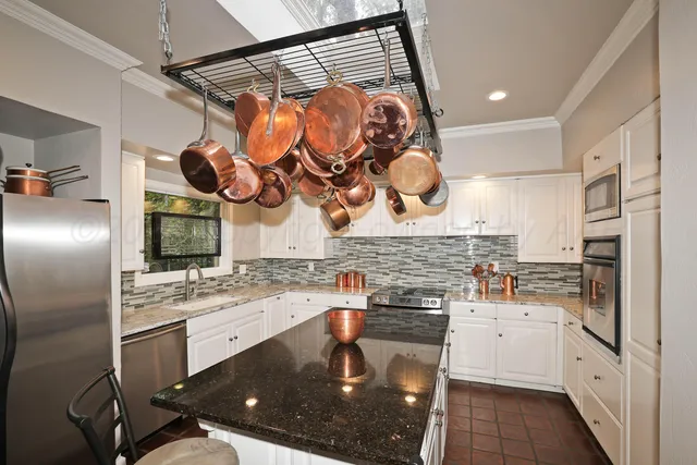 a kitchen with a sink cabinets and stainless steel appliances