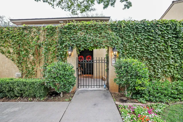 a view of a garden with wooden fence