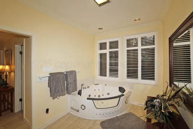 a bathroom with bathtub and window