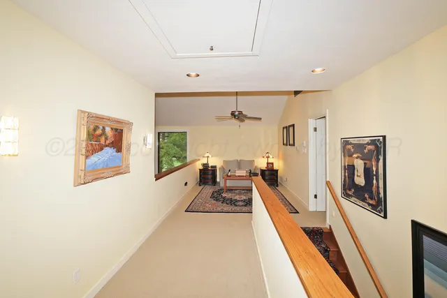 a view of a large room with furniture and wooden floor