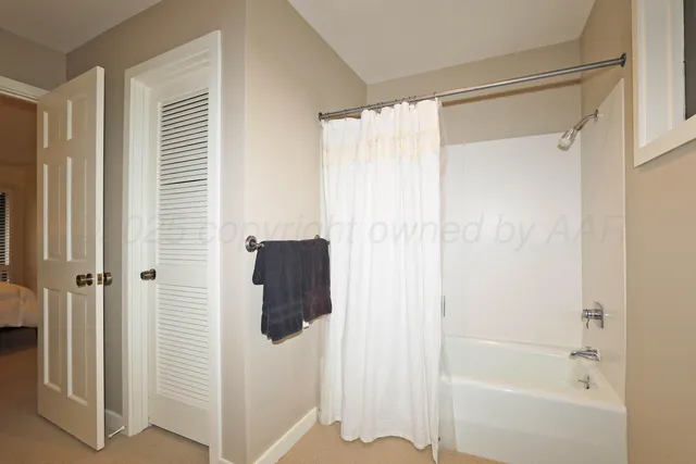 a bathroom with a shower and a tub