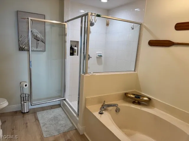 a bathroom with a tub and a shower