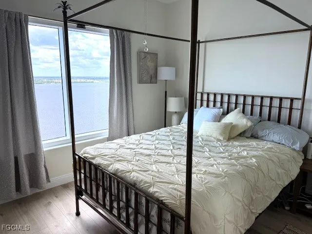 a bed sitting in a bedroom next to a window