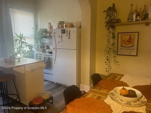a bed sitting in a kitchen next to a window