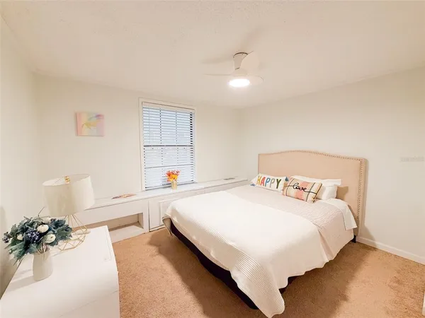 a bedroom with a bed and a potted plant