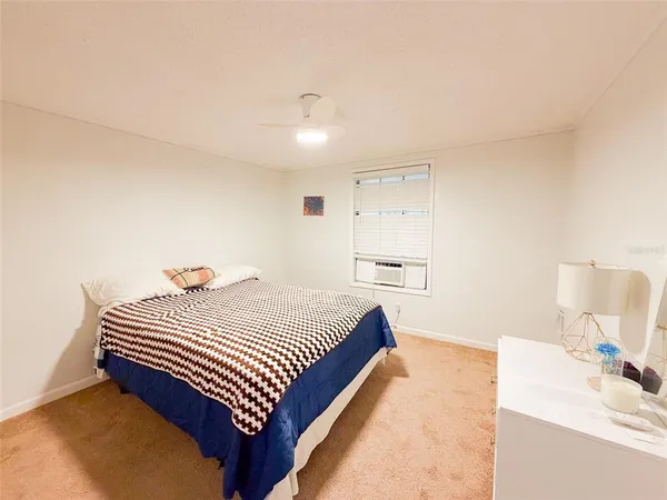 a bedroom with a bed and a mirror