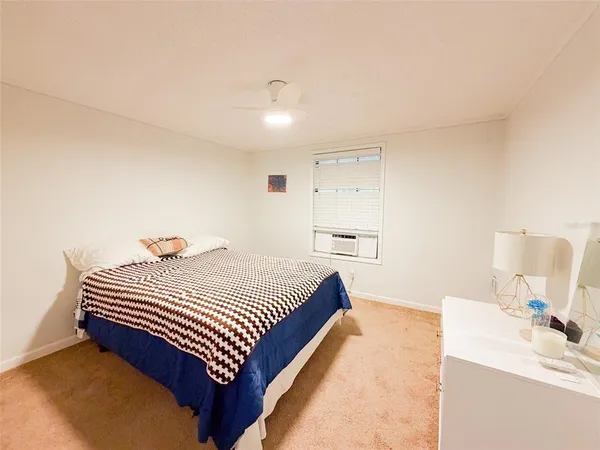 a bedroom with a bed and a table in it