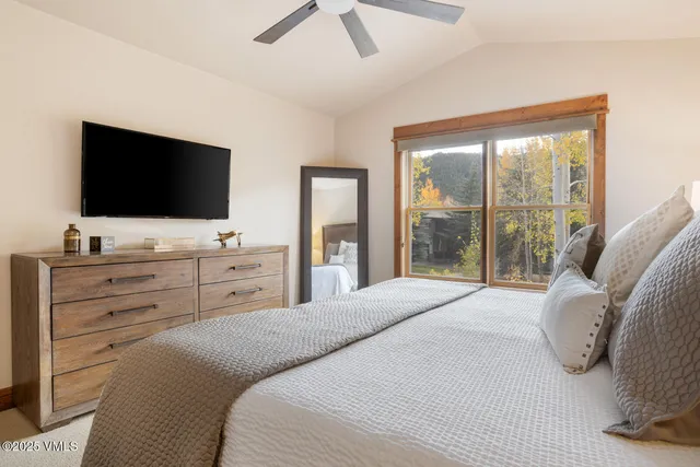 a bedroom with a bed and a flat screen tv