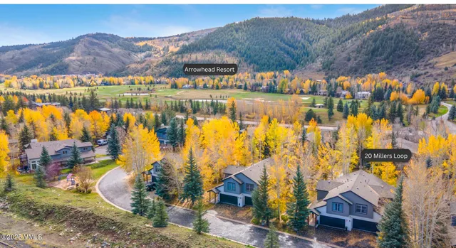 a view of residential houses with outdoor space and river