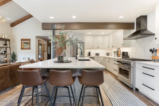 a kitchen with stainless steel appliances a sink stove and cabinets