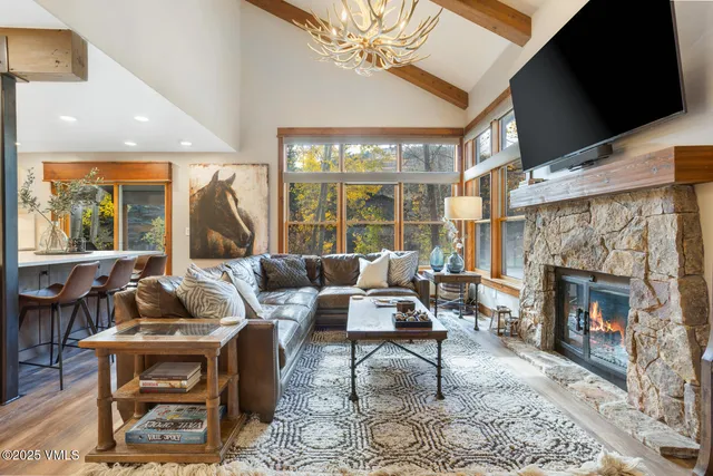 a living room with furniture a fireplace and a flat screen tv