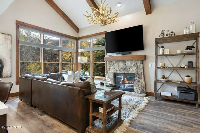 a living room with furniture a flat screen tv and a fireplace