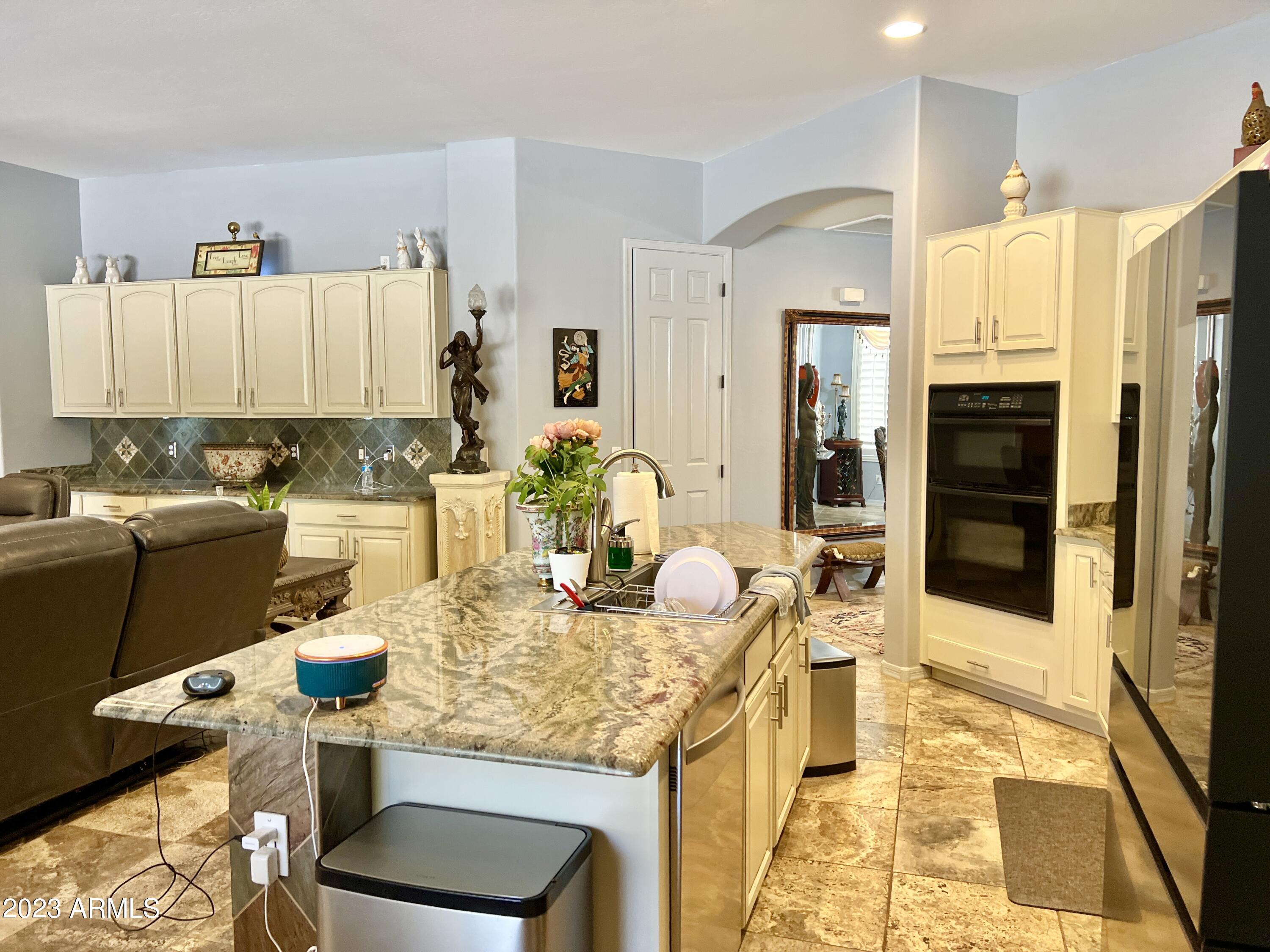 4735 South Rim Road Gilbert, AZ 85297 - Photo 11 of 38 a kitchen with granite countertop a sink appliances and cabinets