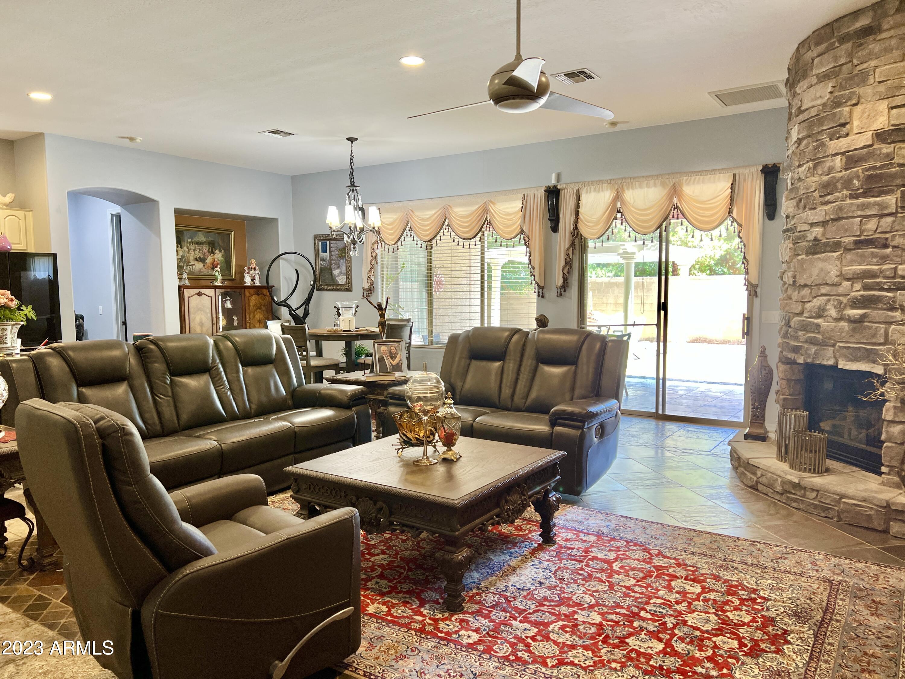4735 South Rim Road Gilbert, AZ 85297 - Photo 16 of 38 a living room with furniture a table and a large window
