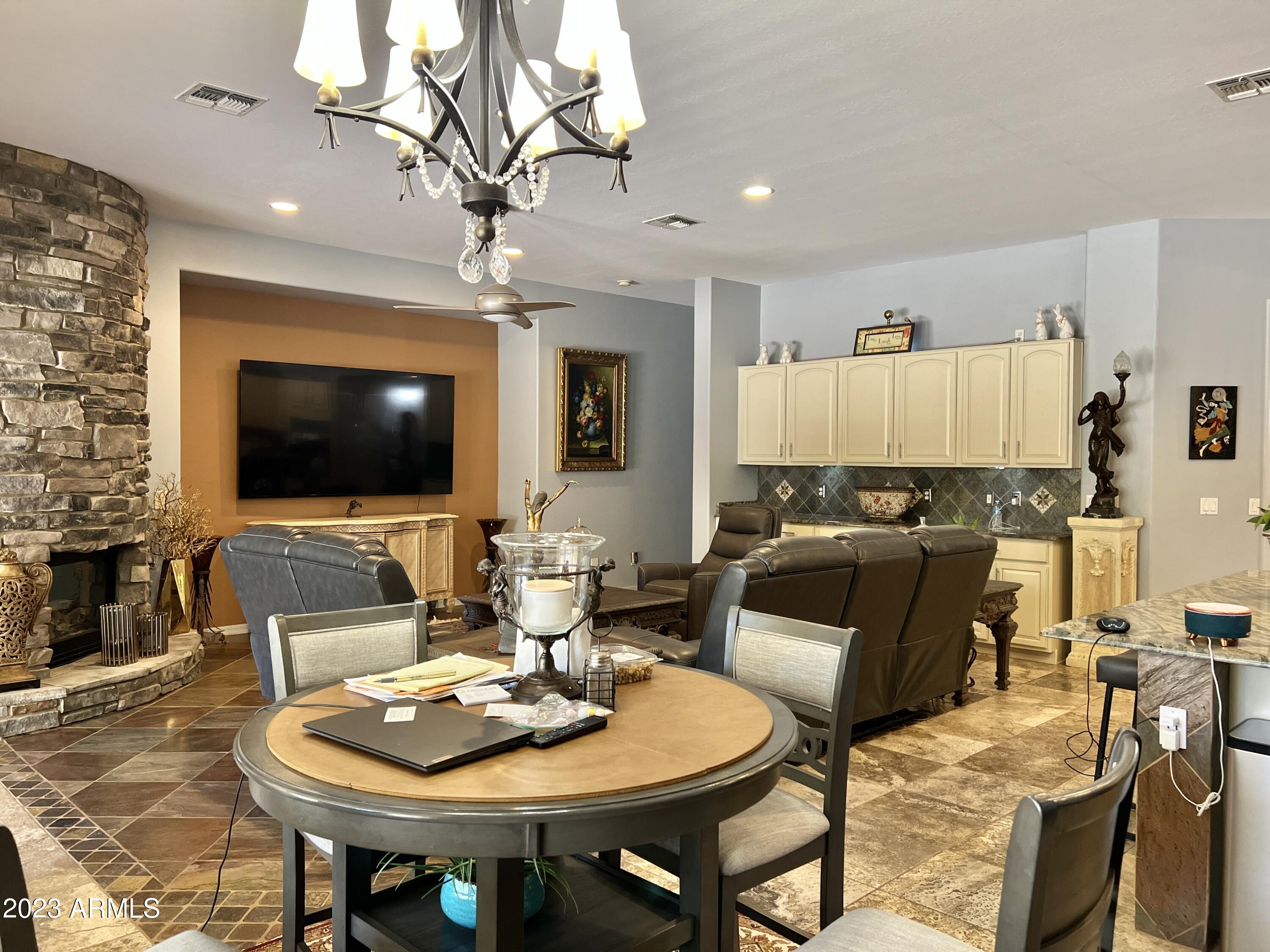 4735 South Rim Road Gilbert, AZ 85297 - Photo 17 of 38 a living room with furniture a flat screen tv and kitchen view