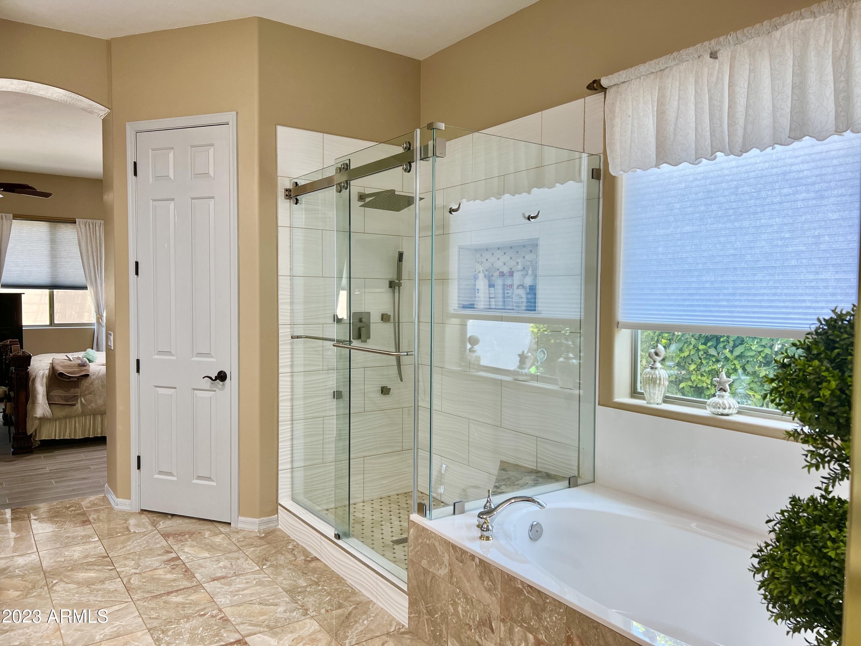 4735 South Rim Road Gilbert, AZ 85297 - Photo 23 of 38 a bathroom with a bathtub and a shower