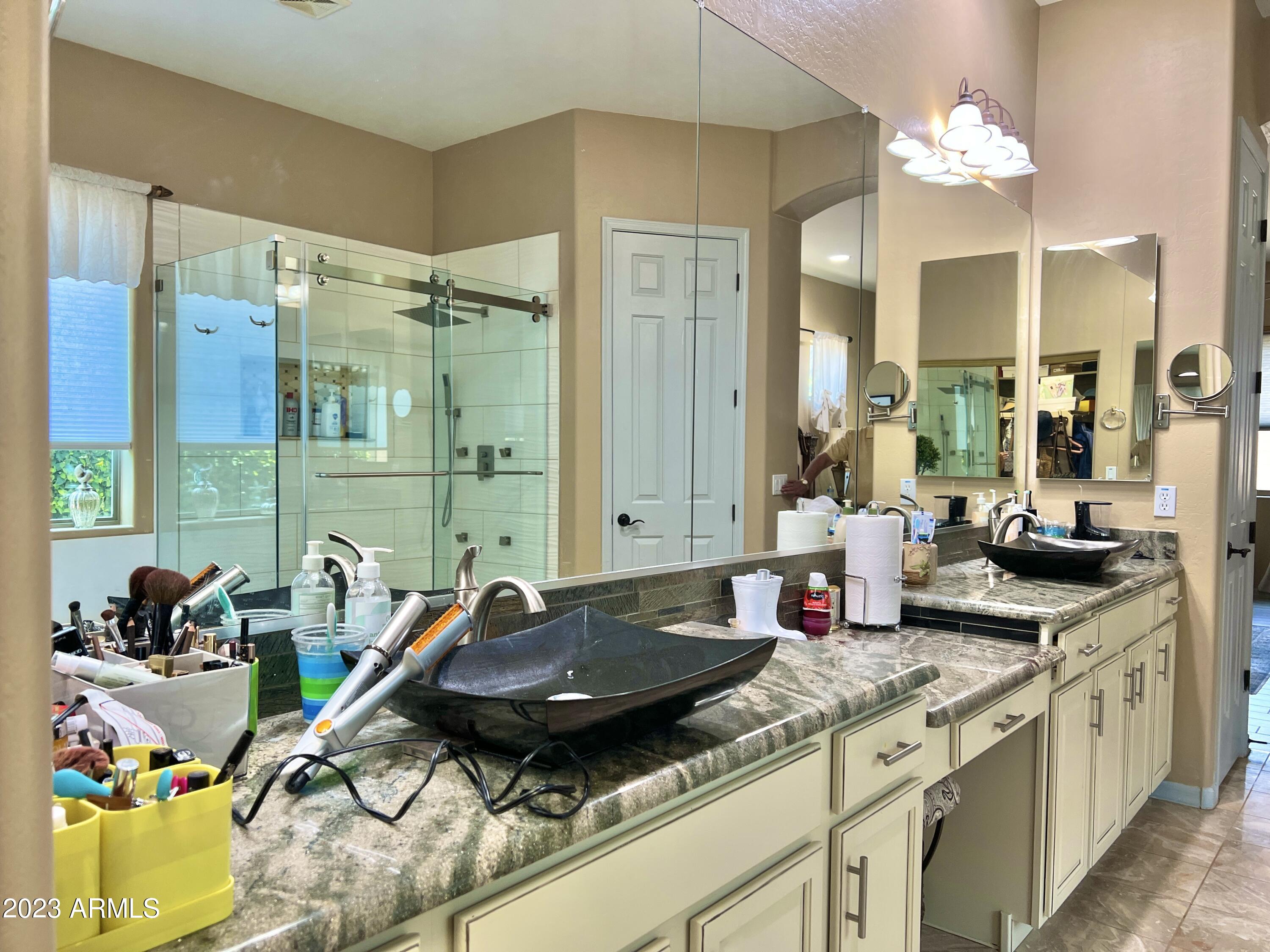4735 South Rim Road Gilbert, AZ 85297 - Photo 24 of 38 a kitchen with kitchen island granite countertop a sink a counter top space and living room view
