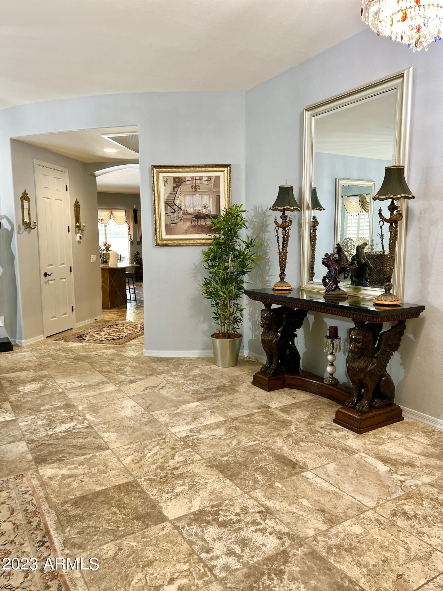 4735 South Rim Road Gilbert, AZ 85297 - Photo 4 of 38 a living room with furniture and a large mirror