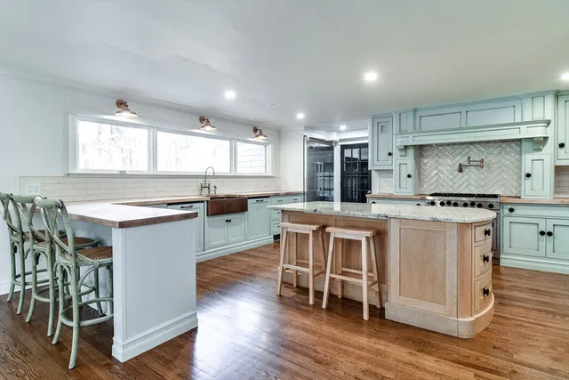 a kitchen with kitchen island granite countertop a sink and counter space