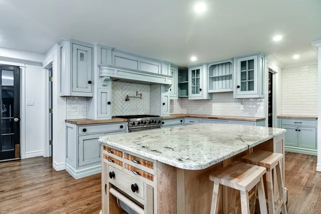 a kitchen with a stove a sink and a refrigerator