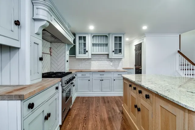 a kitchen with granite countertop white cabinets and white appliances