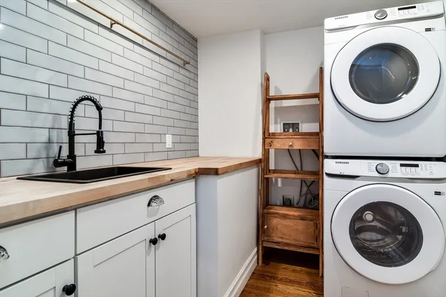 a bathroom with a granite countertop sink a toilet and shower